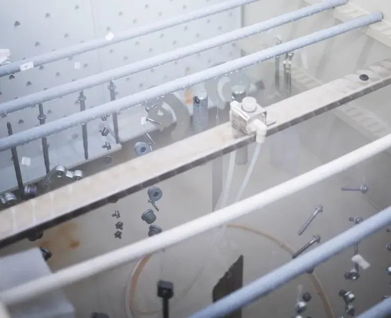 treated parts in salt spray chamber