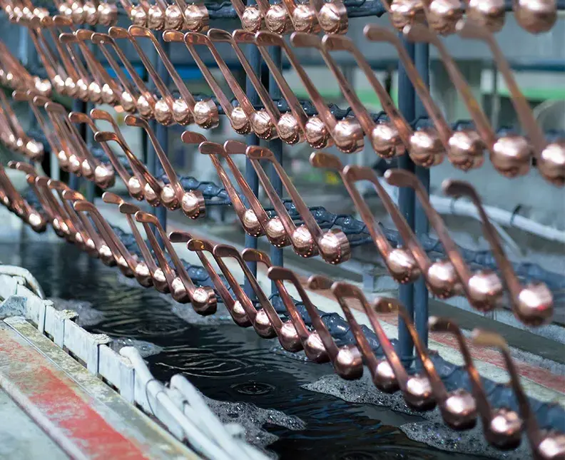 parts treated with CUMAC OPTIMA Dye based bright acid copper on rack