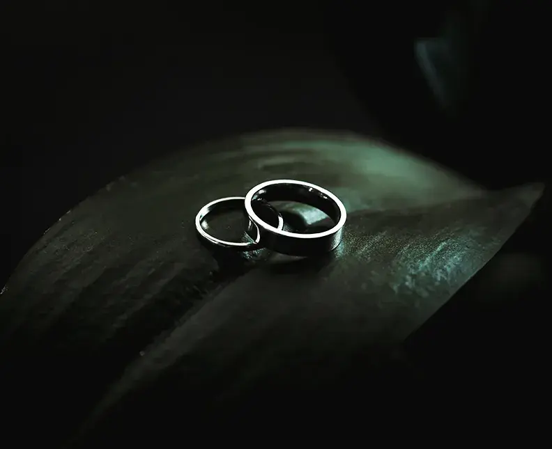 Two silve rings placed on a green leaf