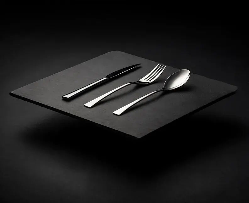 Silver cutlery set on a black background