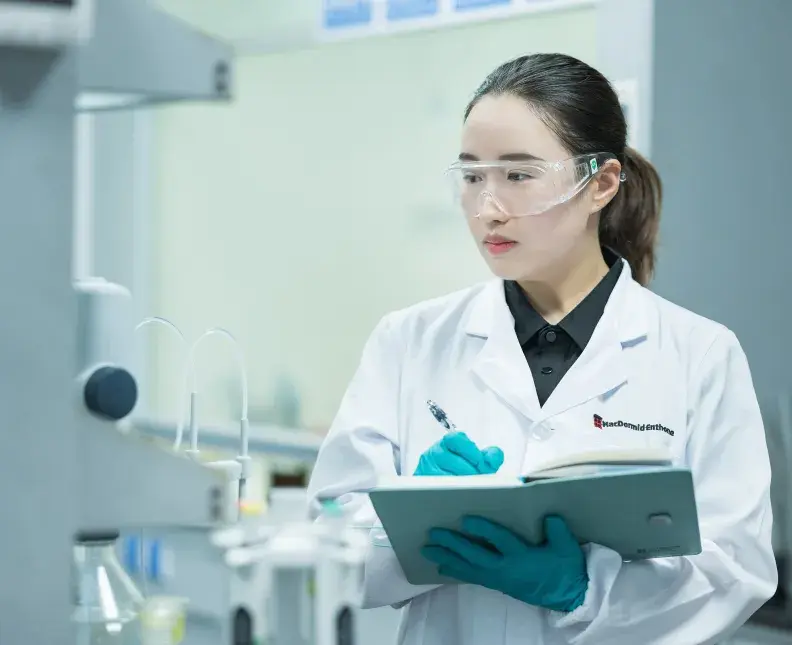 Asian female scientist taking notes in MacDermid Enthone China facility