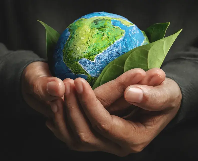 3D render of male hands holding a globe shaped out of clay, wrapped in leaves
