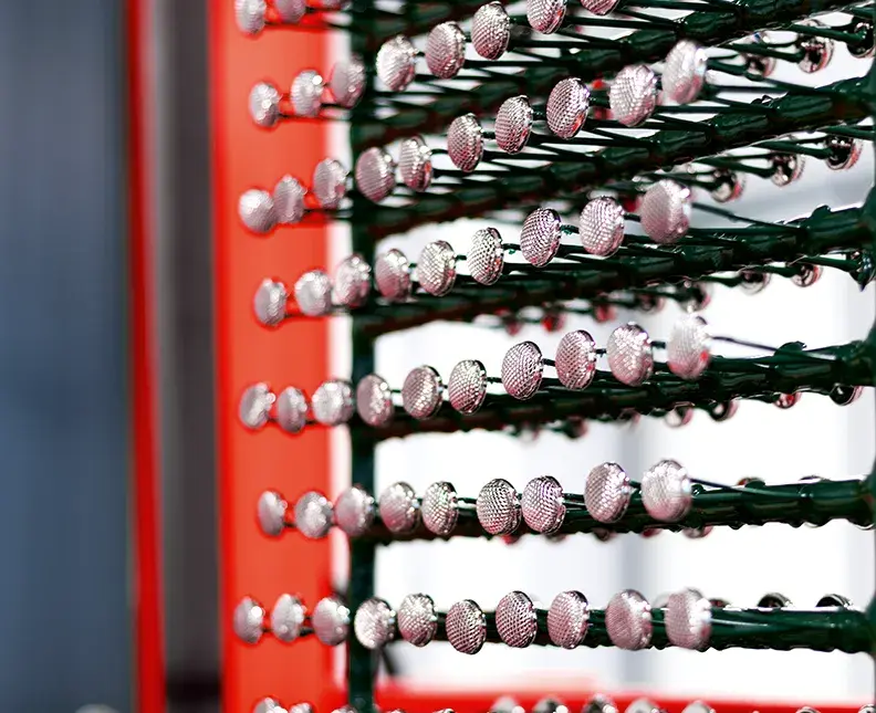 plastic part on rack treated with nickel