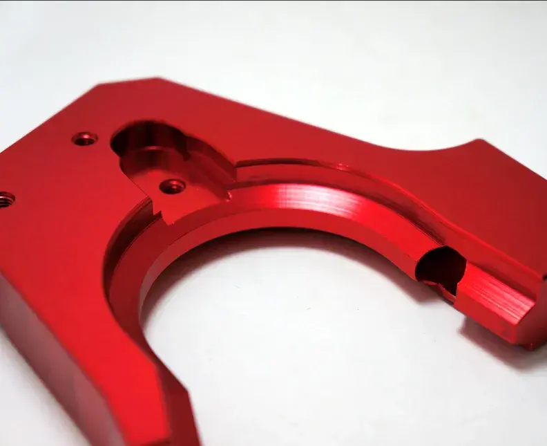 red anodize aluminum part on a light background