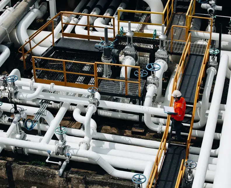 a man in a red jacket performing safety check on an oil rig