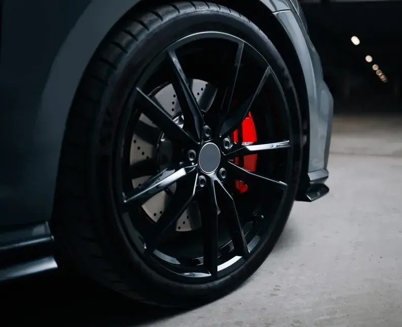 Front wheel of modern car with a red caliper