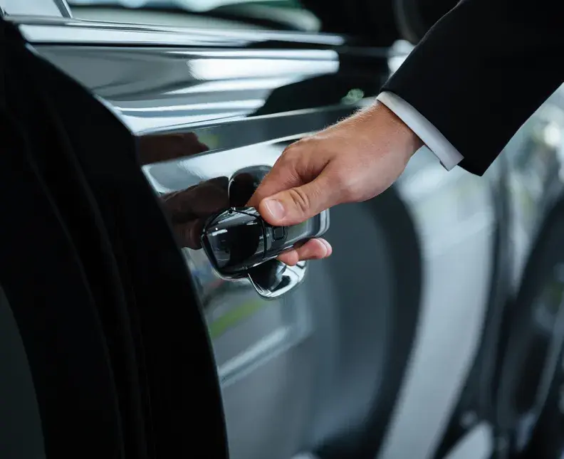 hand reaching for a car door to open it