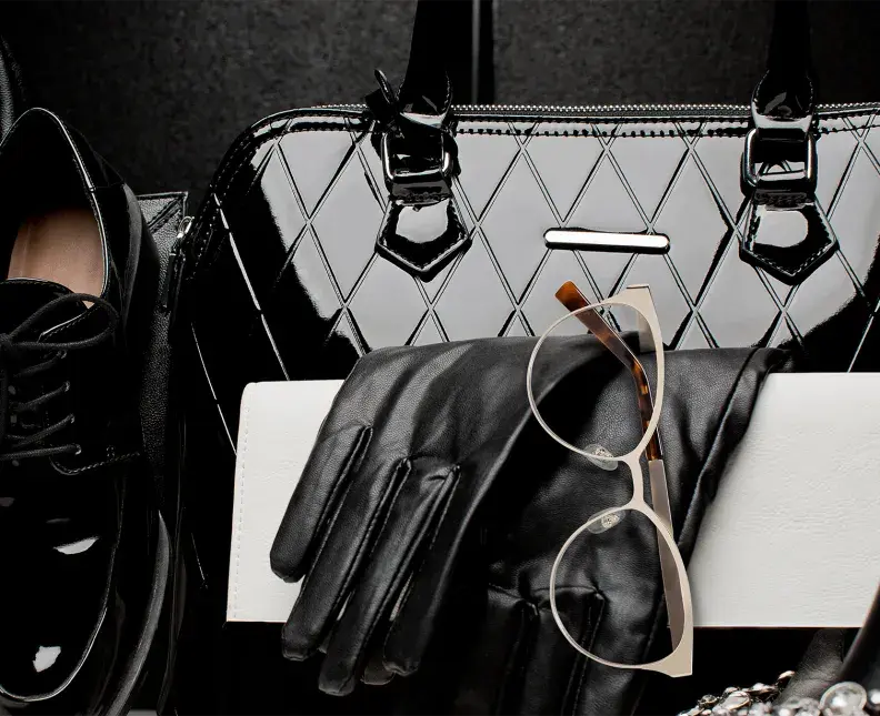 arrangement of purse, shoes and glasses with metallic elemnets