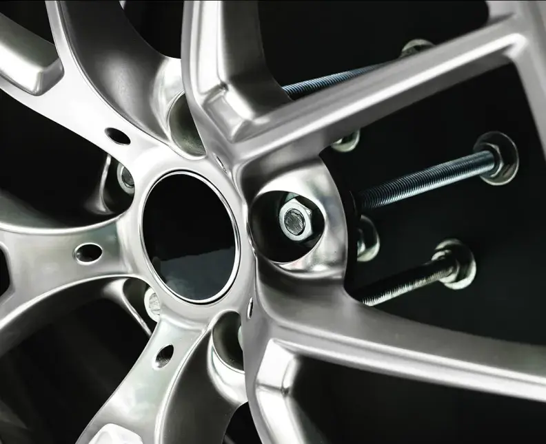 closeup of a car wheel disk with visible fasteners