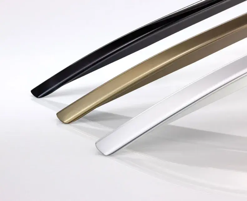 three anodized car roof rails in different colors isolated on a light background, studio shot